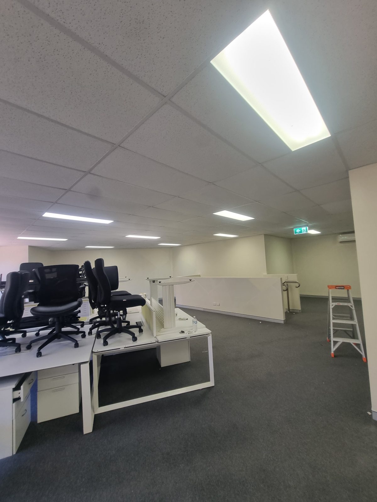 Freshly painted open-plan commercial office with reception desk
